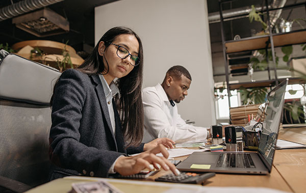 Two employees on laptops